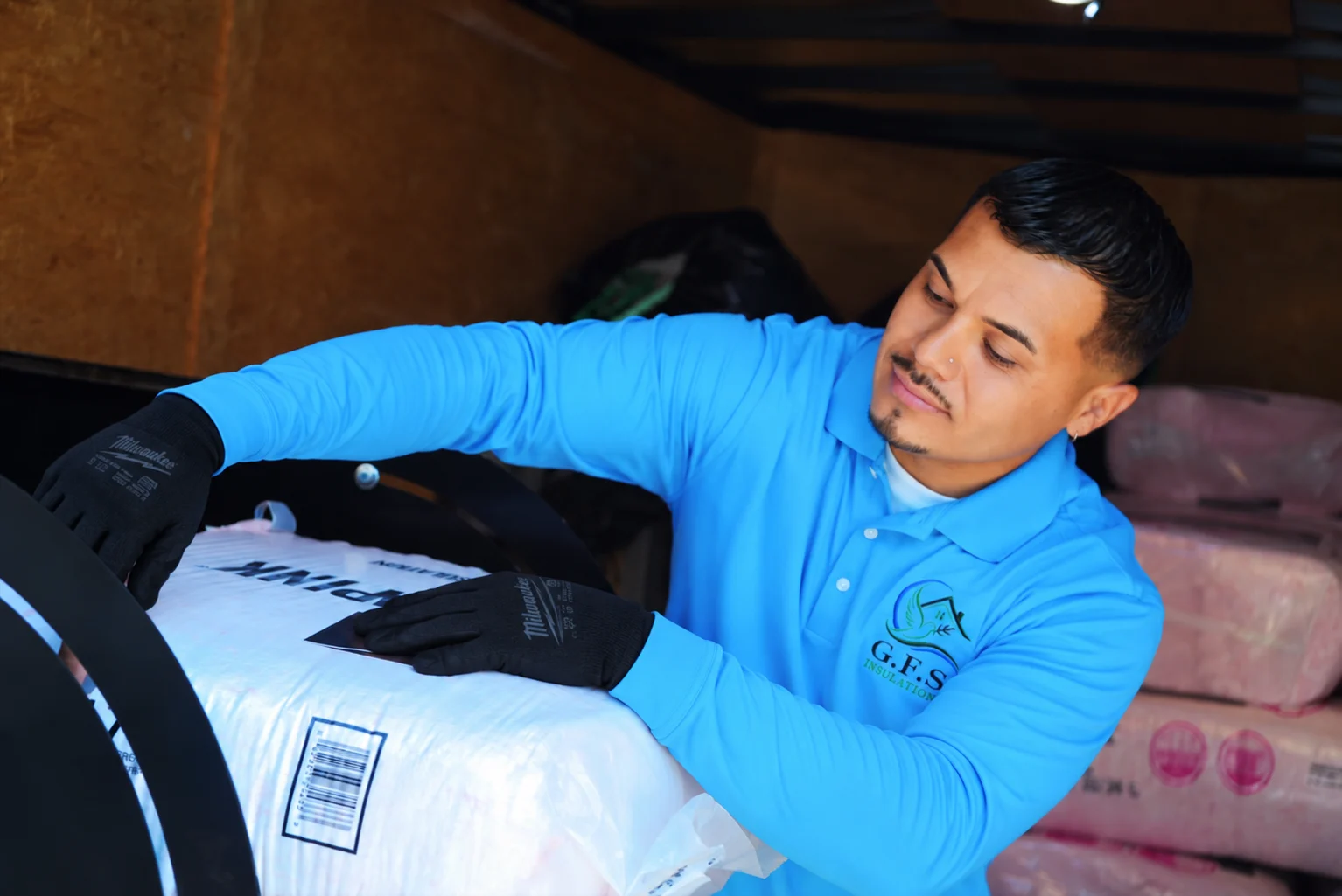 Green Faith Solutions installer preparing insulation in an attic