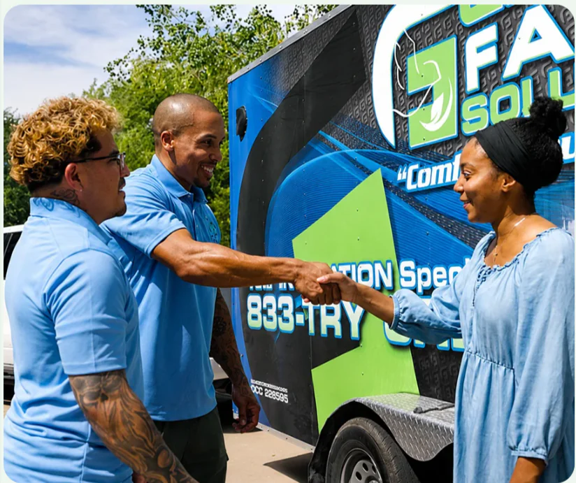 Green Faith Solutions team greeting a homeowner beside the company trailer