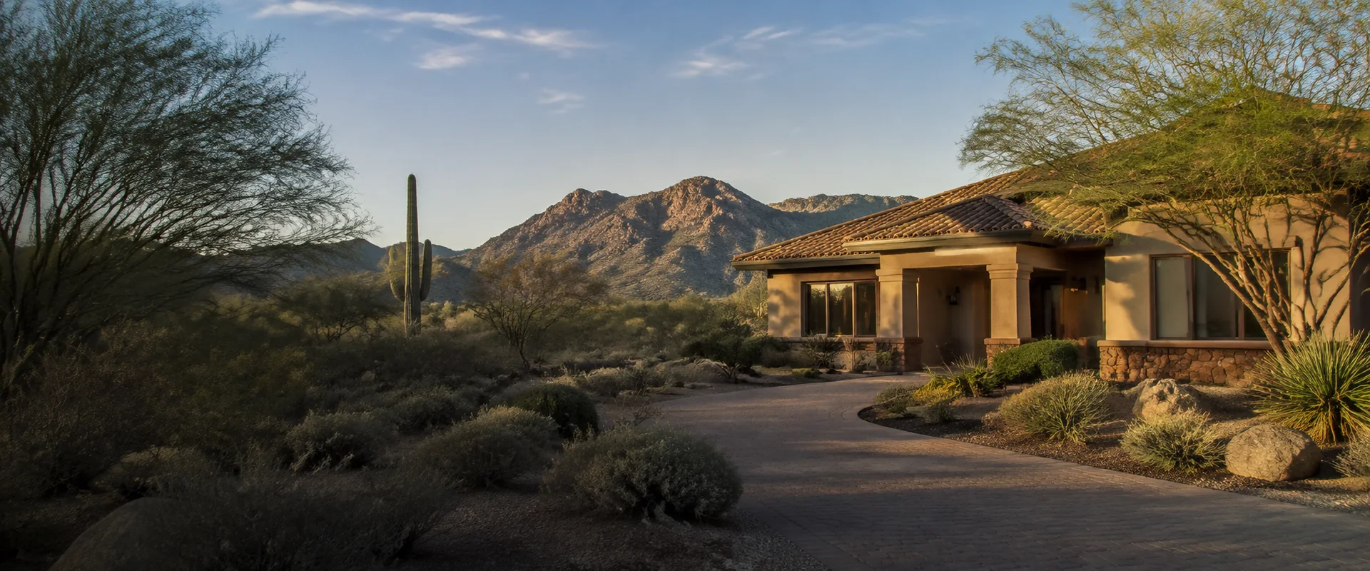 Illustrative Arizona desert home with a tile roof, native landscaping, and mountain views